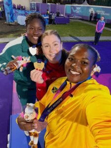 Jessica Oji of Team Nigeria holding her silver medal alongside gold medallist Sarah Mitton of Canada and bronze medallist Lloydricia Cameron of Jamaica at the Glasgow 2026 Commonwealth Games women