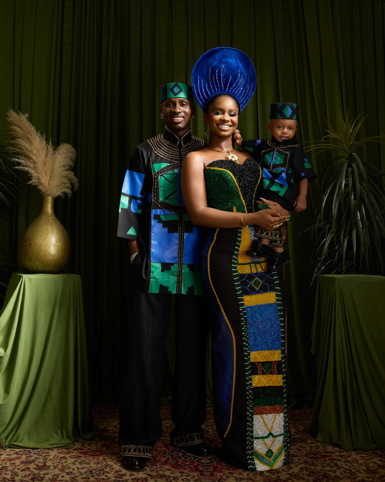 Priscilla Ojo and Juma Jux smiling at the camera holding baby Rakeem.