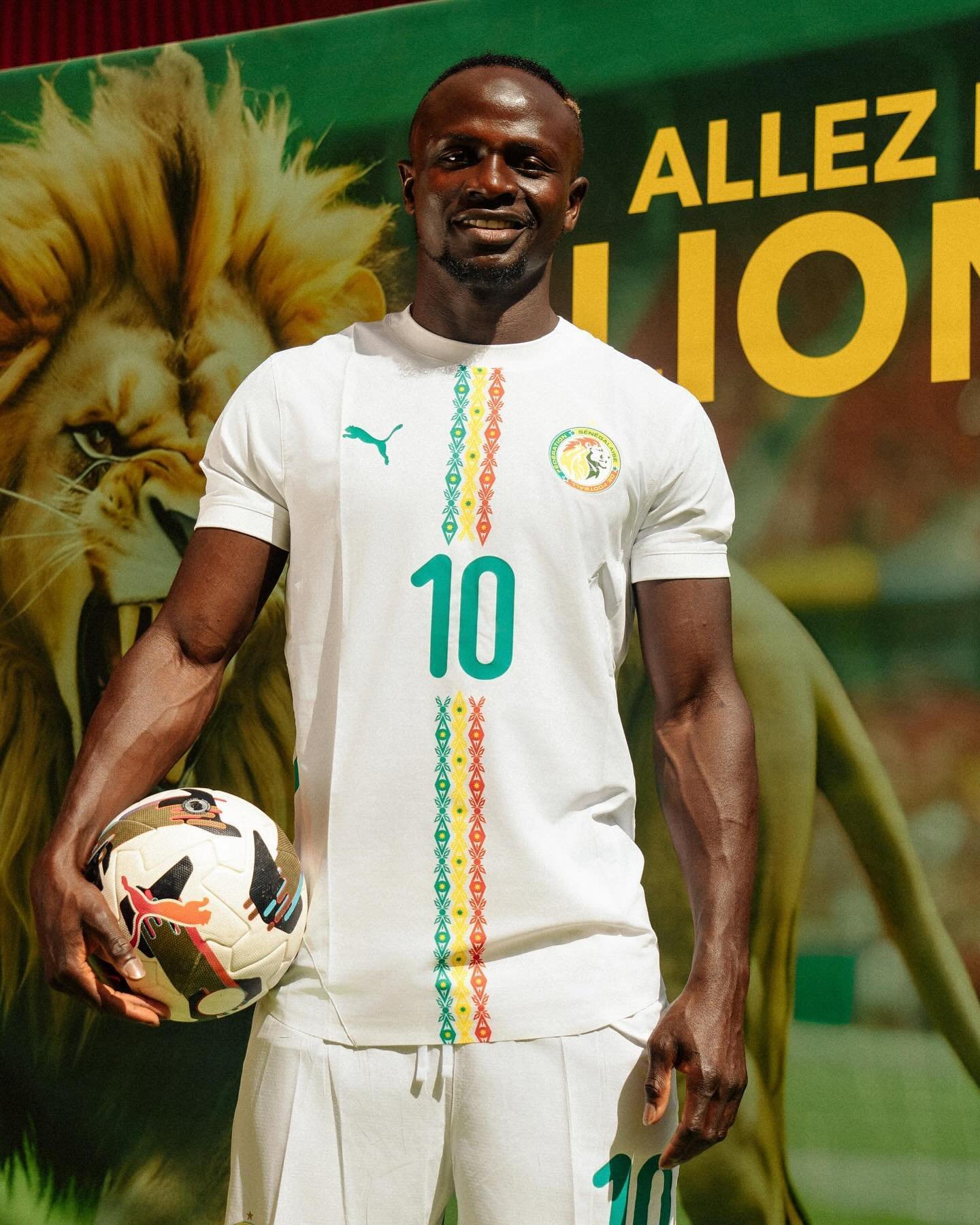 Sadio Mané wearing the white Senegal national football team jersey with number 10 holding a match ball