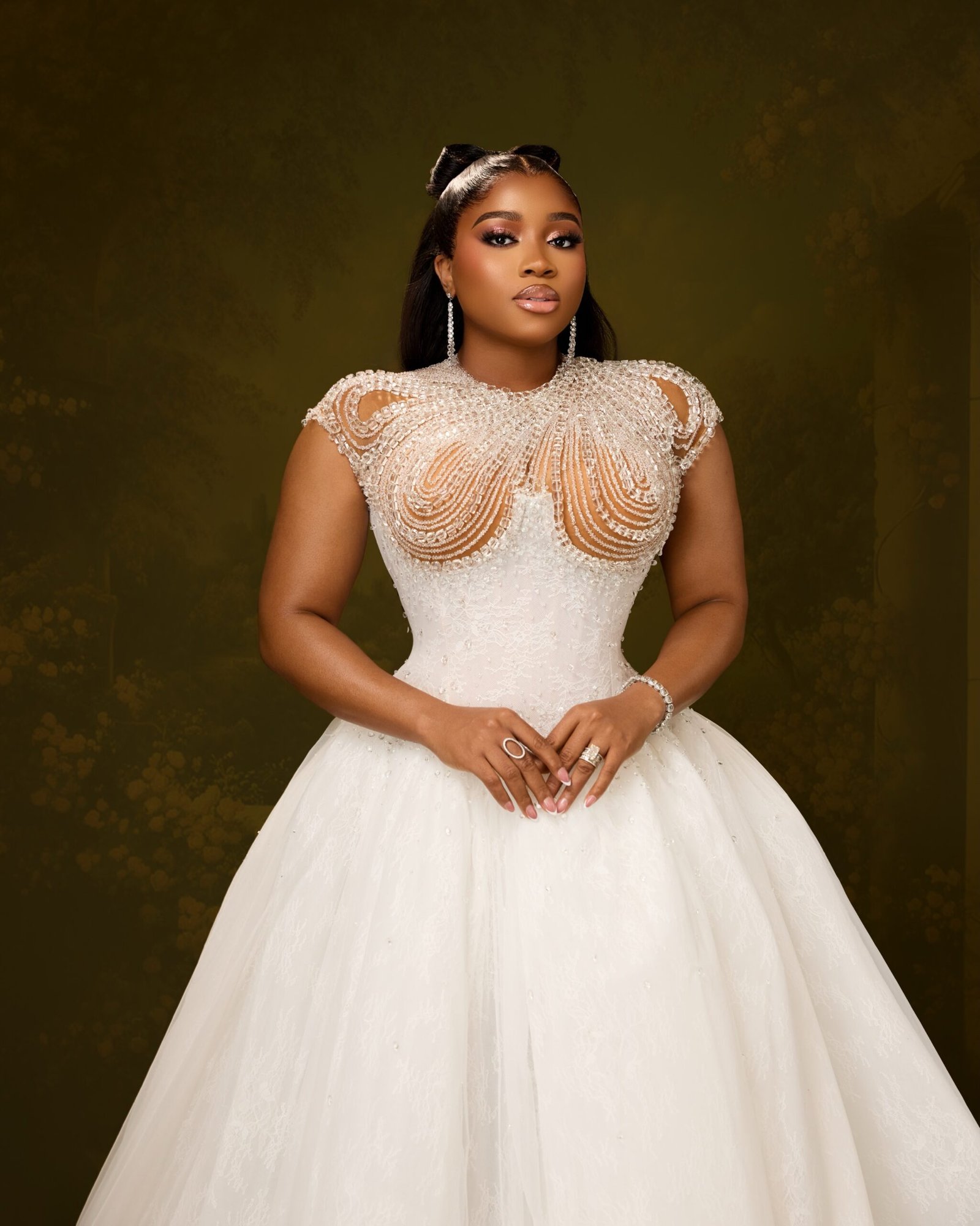 Veekee James displaying a crystal beaded sheer bodice and half-up bow hairstyle