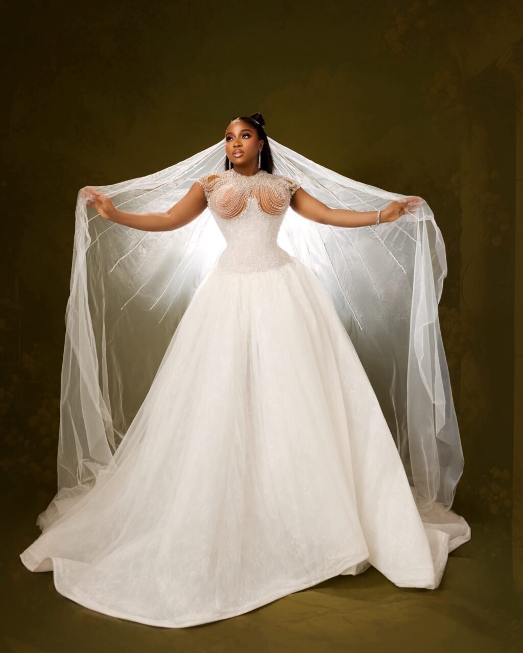 Veekee James in a full white basque-waist ballgown with an embellished corset