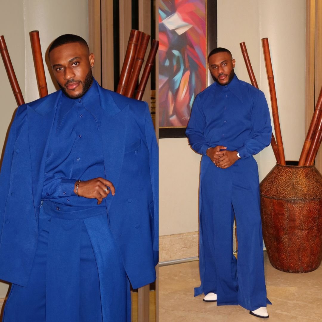 Kola Omotosho wearing a royal blue high-collar shirt with matching wide jacket and wide trousers at BellaNaija event.