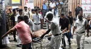 Medical-workers-move-an-injured-police-officer-on-a-stretcher-following-the-Durga-Puja-Pandal-stampede