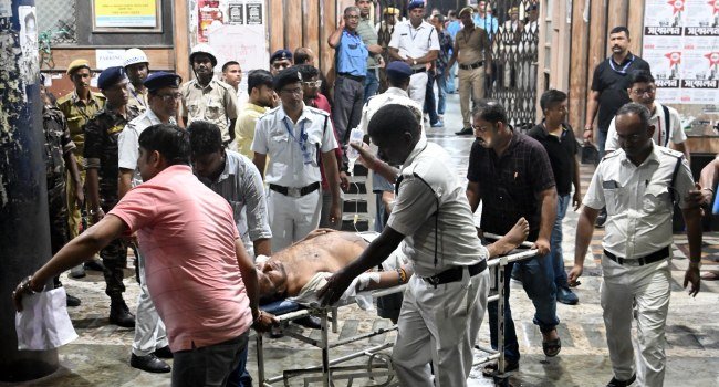 Medical-workers-move-an-injured-police-officer-on-a-stretcher-following-the-Durga-Puja-Pandal-stampede