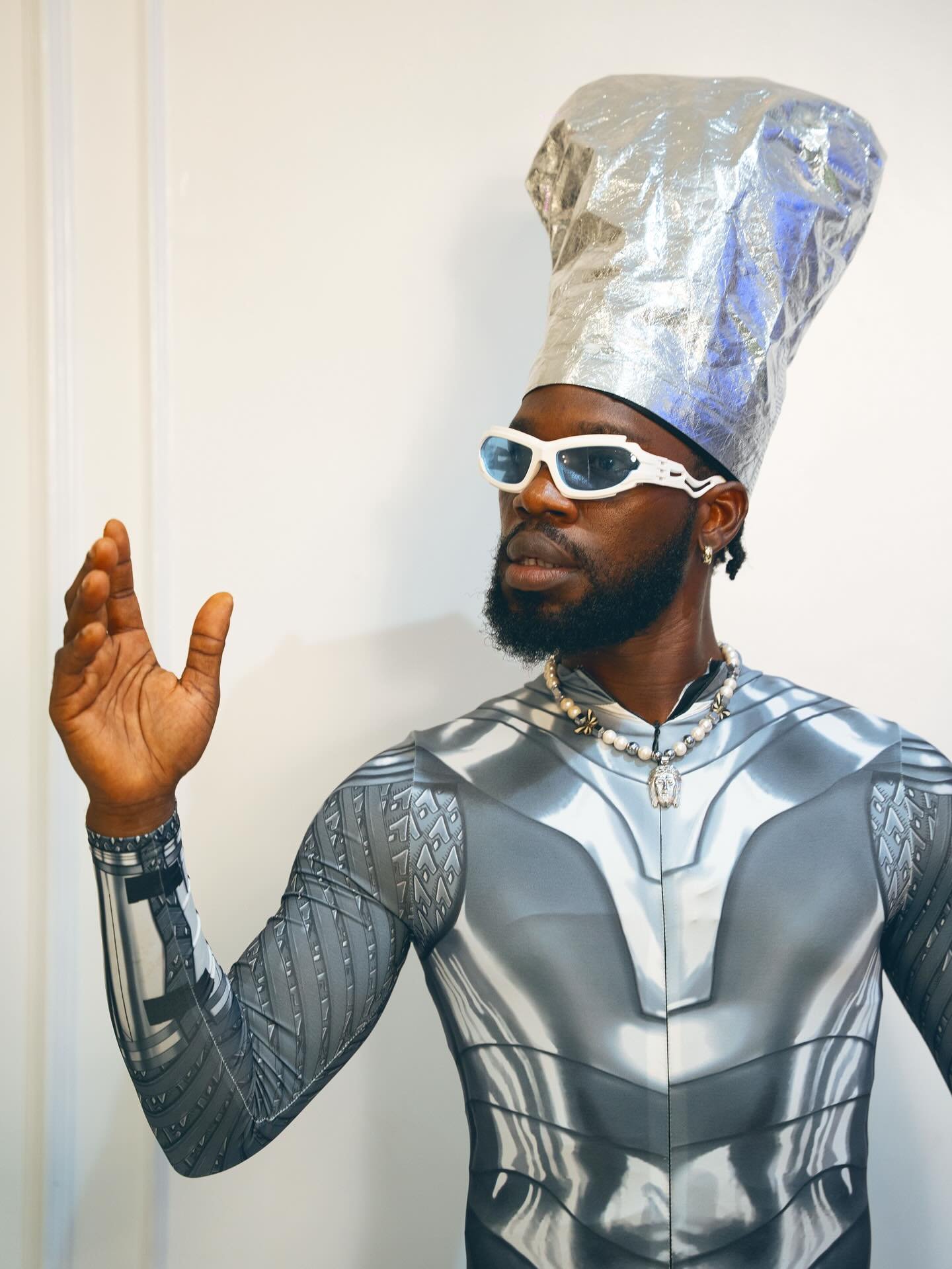Broda Shaggi wearing a silver futuristic costume and foil hat during a video skit shooting session.