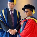 Folorunso Alakija wearing a red academic gown alongside Vice-Chancellor Professor David Cole in ceremonial robes.